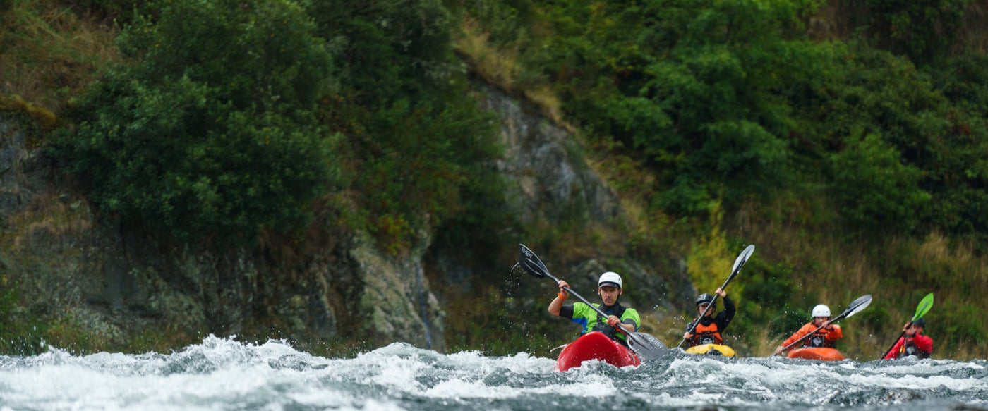 Four kayakers on Grade 2 Kayak course in North Island New Zealand